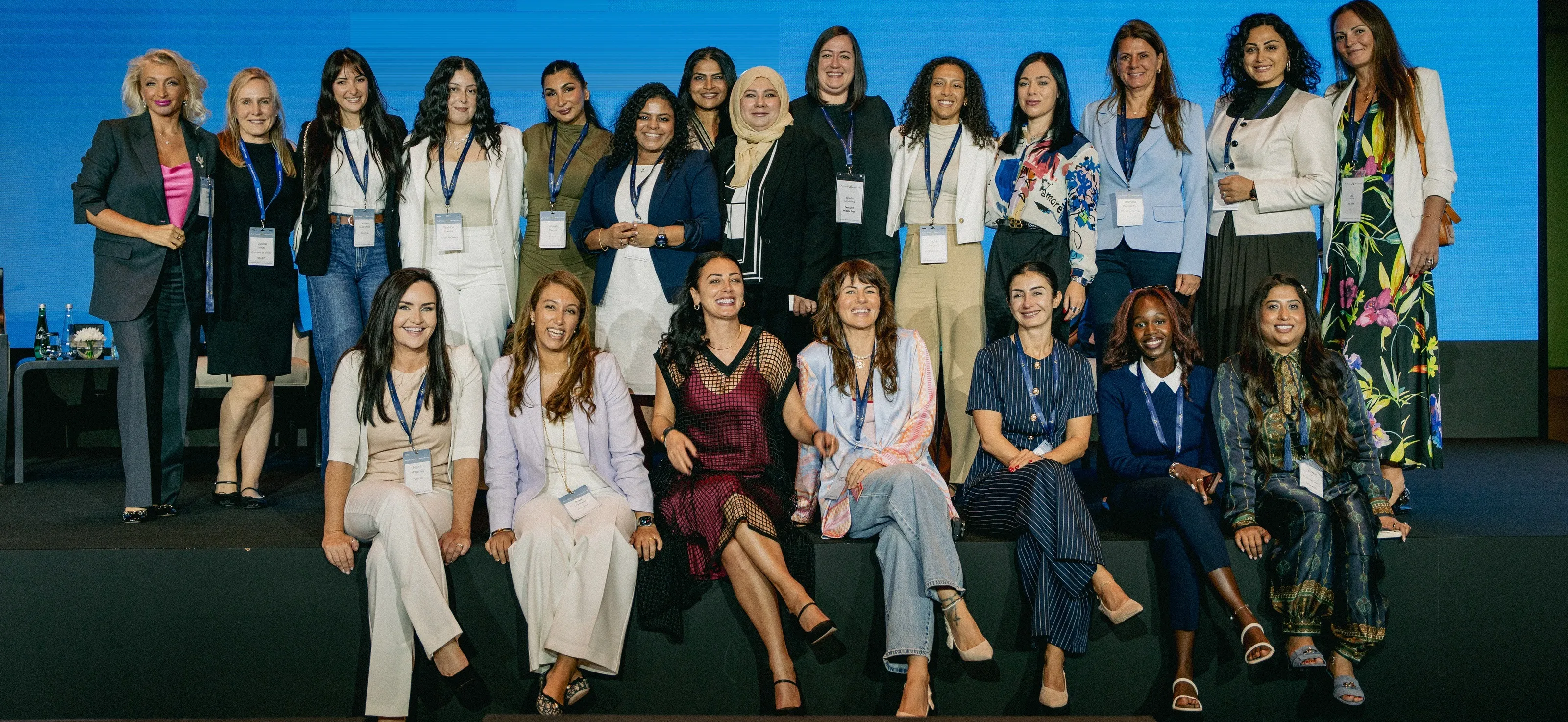 Members of Aviatress together on stage at a conference, in front of a blue backdrop.